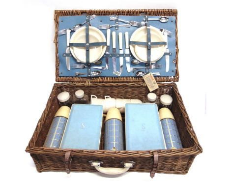 A SIRRAM PICNIC SET with settings for six, in a wicker basket; together with a folding picnic table.