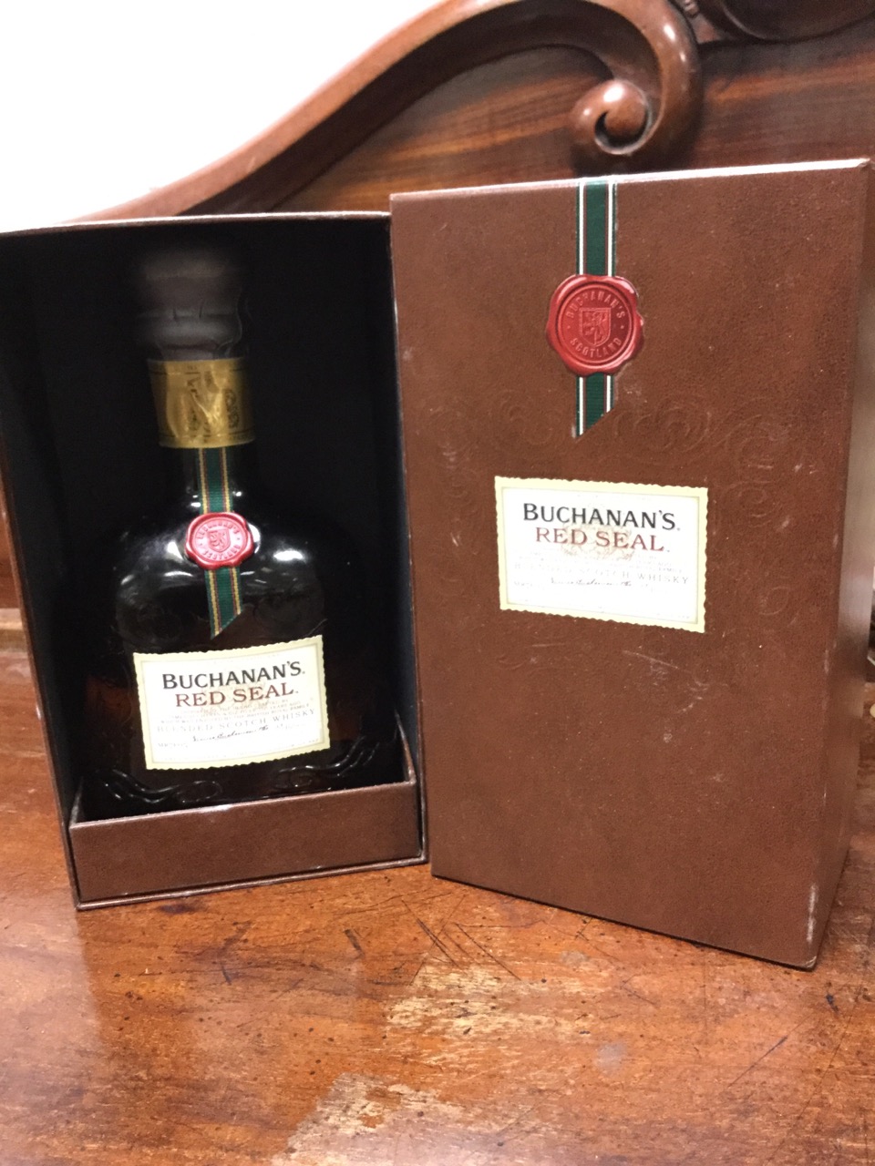 A boxed bottle of Buchanans Red Seal scotch whisky, the scroll embossed