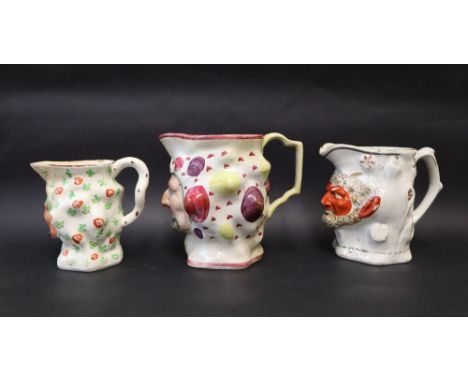 Three assorted 19th century Staffordshire Bacchus / satyr faced jugs, Prattware and Pearlware