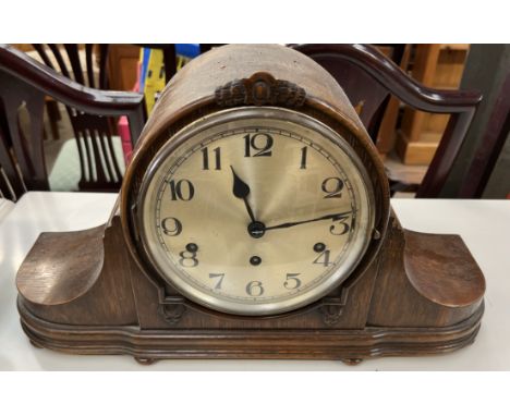 An oak cased Napoleon hat mantle clock, with a silvered dial and Arabic numerals