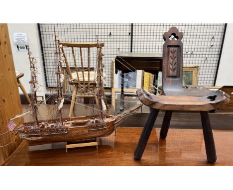 A scratch built model ship together with a stool