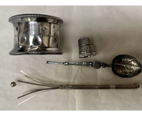 A sterling silver swizel stick, silver napkin ring, thimble and spoon