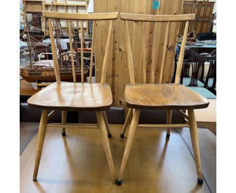 A pair of mid 20th century stick back dining chairs on turned legs