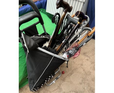 A collection of umbrellas, walking stick etc 