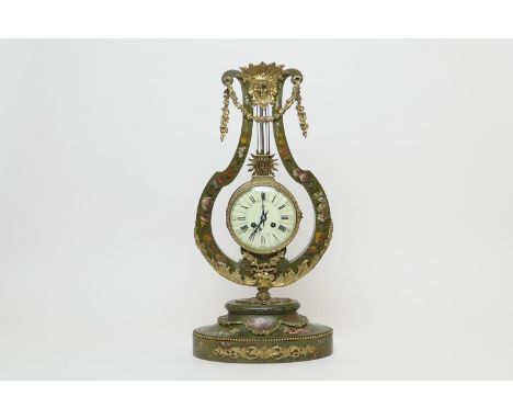 French painted wooden and ormolu mounted lyre form mantel clock, circa 1900, surmounted with a mask and floral garlands with 