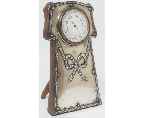 Edwardian silver faced desk barometer, white printed 5cm dial inscribed 'Made in London', set in silver decorated with a tied