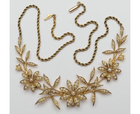 Late Victorian 15ct gold pearl floral necklace, circa 1900, having three flowerheads inset with split pearls, articulated bet