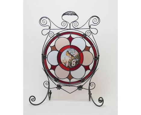 Arts and Crafts period wrought iron and stained glass firescreen, circa 1900, centred with a stained glass roundel featuring 