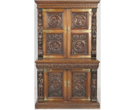 Victorian Flemish carved oak cabinet, the upper part with two cupboard doors, each with carved double portrait medallions wit