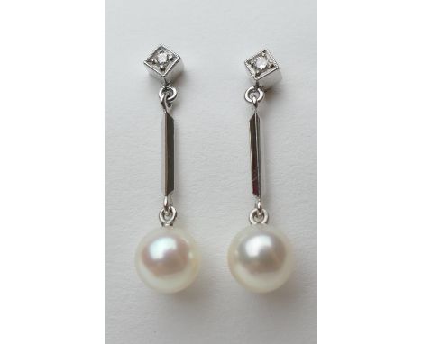 Pair of diamond and cultured pearl pendant earrings, in 14ct white gold, the pearls of approx. 13 metric grains, suspended fr