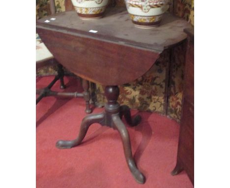 A George III mahogany tripod table with drop leaf  