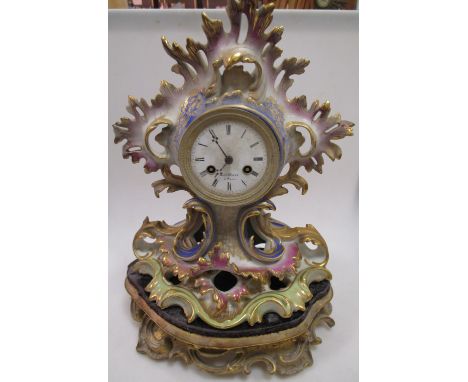 A Paris porcelain mantle clock, on stand, lacking glass globe  