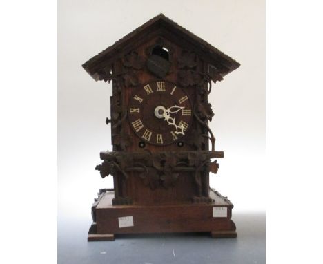 A late 19th century carved case cuckoo clock, twin train, gong striking, 36cm high  