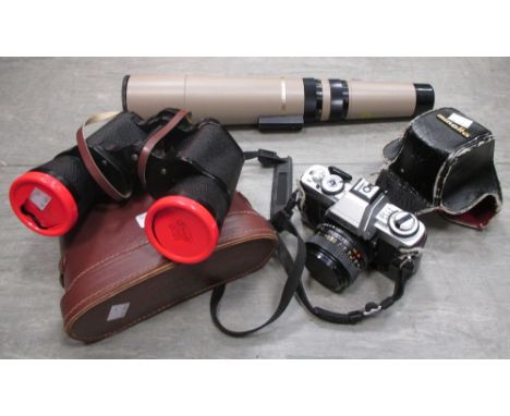 A Minolta 35mm camera, pair of binoculars, and a Bausch & Lomb 60mm telescope  