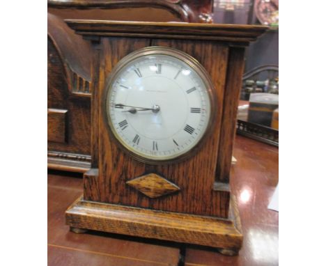 An oak mantel clock, a smaller clock and a metal cased clock (3)  