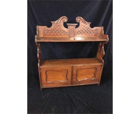 A mahaogany wall shelf with cupboard