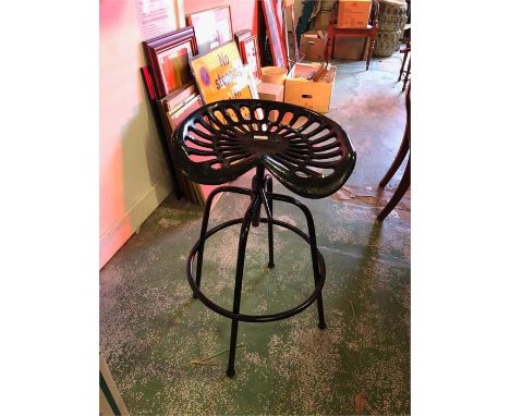 A Black tractor seat stool