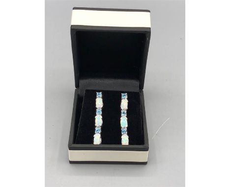 A pair of silver opal and blue topaz earrings