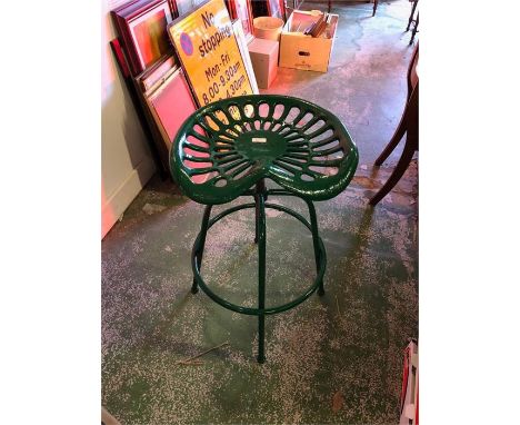 A Green tractor seat stool