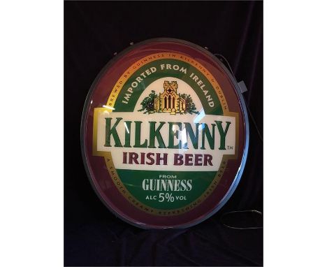 An illuminated Kilkenny beer sign with original swing bracket and taken out of box for photo.