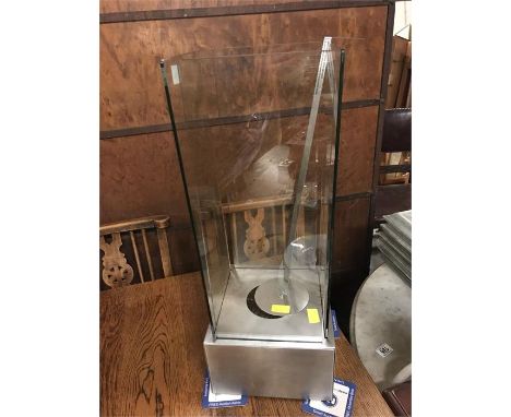 A tall brushed steel and glass outdoor lamp
