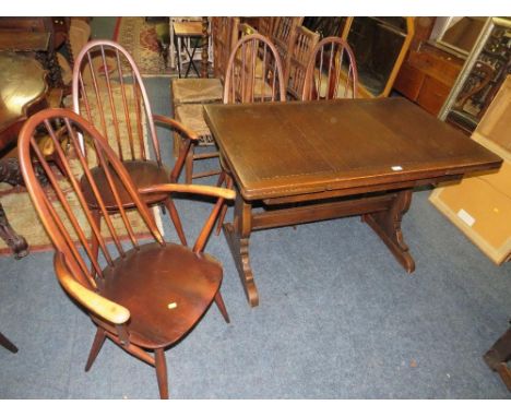 An Ercol dining set comprising an extending table and four chairs