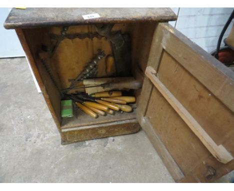 A wooden storage cabinet and contents - tools