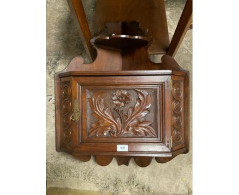 A vintage carved mahogany wall corner cupboard