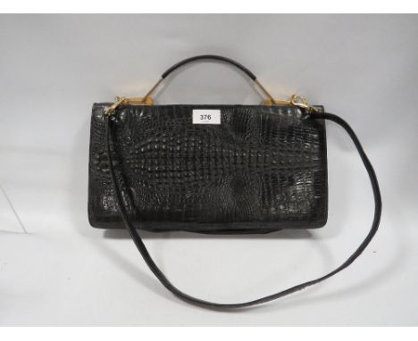 A vintage alligator skin type handbag