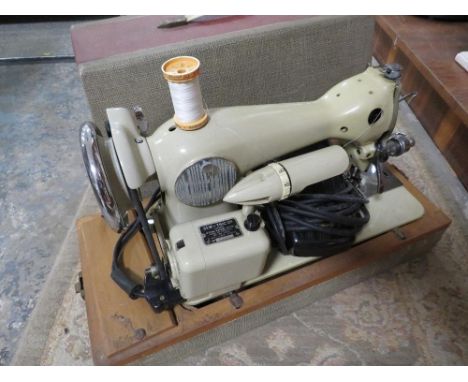 A vintage cased Cresta electric sewing machine