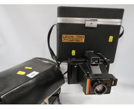 A vintage cased polaroid land camera super colour swinger III together with a vintage cased video camera