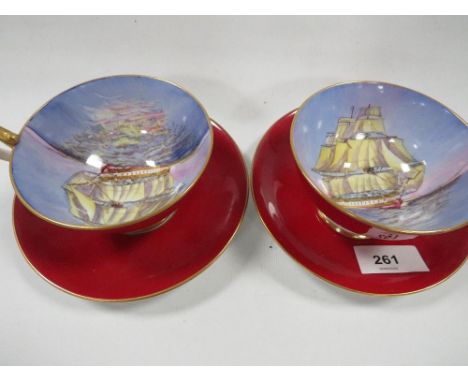 Two Aynsley cups and saucers, decorated internally with tall sail ships