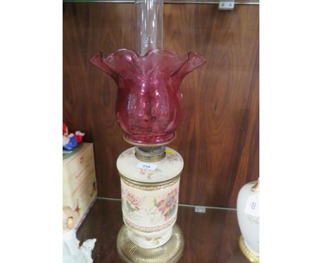A vintage ceramic oil lamp with cranberry style shade -top loose