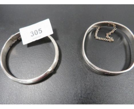 A hallmarked silver bangle with another unmarked example (2)