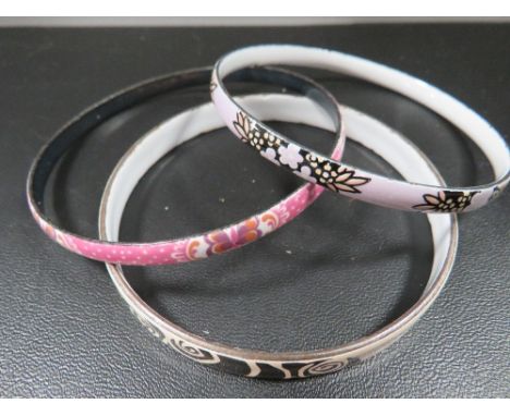 Two Michaela Fray enamel bangles together with a similar unmarked example (3)