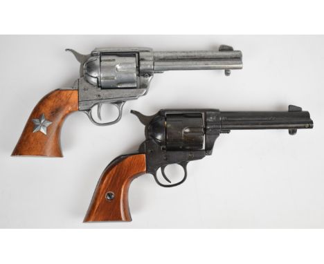 Two Colt Single Action Army .45 style six shot single action revolvers, both with shaped wooden grips and 4.75 inch barrel.&n