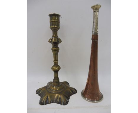 An 18th Century single seamed petal based candlestick, together with a Swaine &amp; Co. copper and nickel plated hunting horn