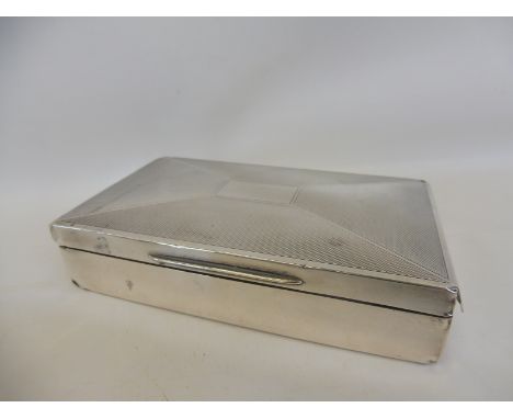 A silver rectangular cigarette box with engine turned decoration, Birmingham 1939.