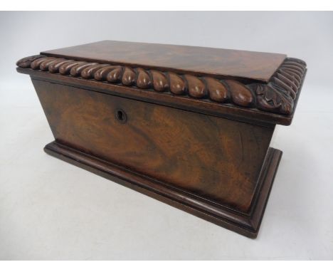 A Victorian mahognay tea caddy with gadrooned decoration.