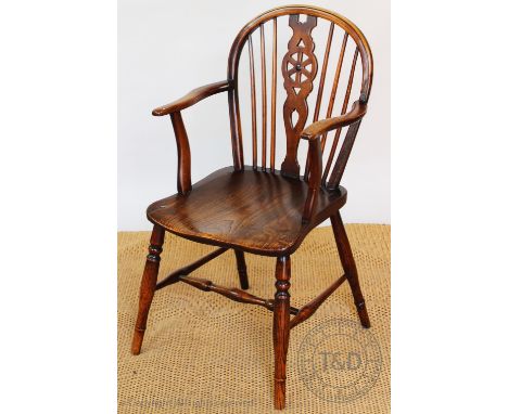 A 19th century ash and elm Windsor type wheel back chair, with saddle seat, on turned legs, 90cm H CONDITION REPORT: There ha