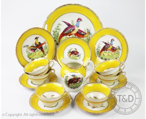 A Continental porcelain 18th century style tea service, each piece decorated with exotic birds within a yellow border, compri