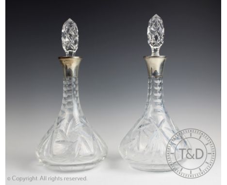 A pair of silver collared decanters and stoppers, ESC, Birmingham 1974, each silver mounted decanter with trumpet shaped face