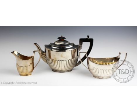 A Victorian three piece silver tea service, Elkington & Co, Birmingham 1886, each of oval, stop fluted form, the teapot with 