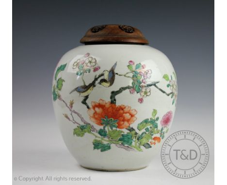 A 19th century Chinese porcelain ginger jar and cover, decorated externally in famille rose with birds perched amongst flower