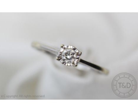 A diamond solitaire ring, the brilliant cut diamond, illusion set in 9ct white gold, stamped 'Dia .10', weight 1.7gms 