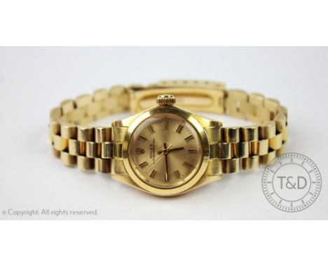 A ladies Rolex Oyster Perpetual 18ct gold wristwatch, the circular gilt dial with centre sweep seconds, yellow gold case and 
