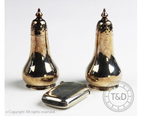 A pair of silver pepperettes Atkin Brothers, Sheffield 1927, each of rounded form and a silver vesta case Joseph Gloster Ltd,