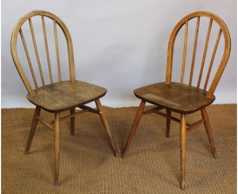 An Ercol elm dining table, on tapered legs, 71cm H x 148cm W x 75.5cm D and six chairs and two smaller Ercol pebble tables (a