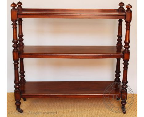 A Victorian mahogany three tier buffet, with turned baluster supports and brass casters, 126cm H x 129cm W x 45cm D  CONDITIO