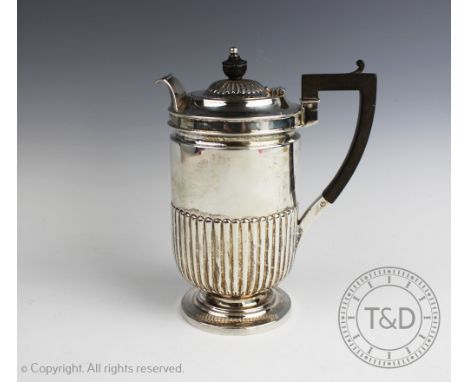 An Edwardian silver hot water pot, Fenton Brothers Ltd, Sheffield 1902, the barrel shaped pot with embossed fluted lower sect